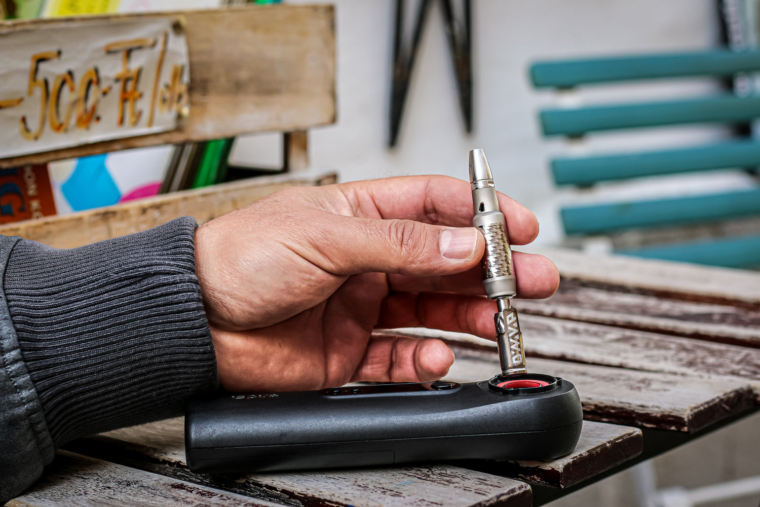 Hand holding Dynavap vaporizer and induction heater