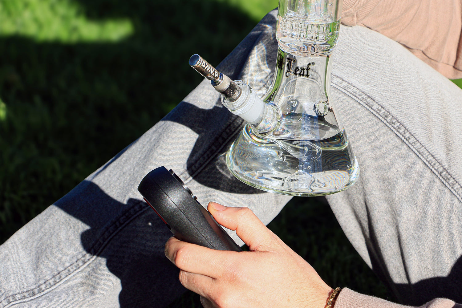 Glass bong with portable vaporizer outdoors