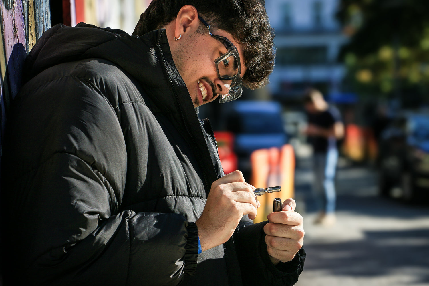 Man preparing a vape device outdoors